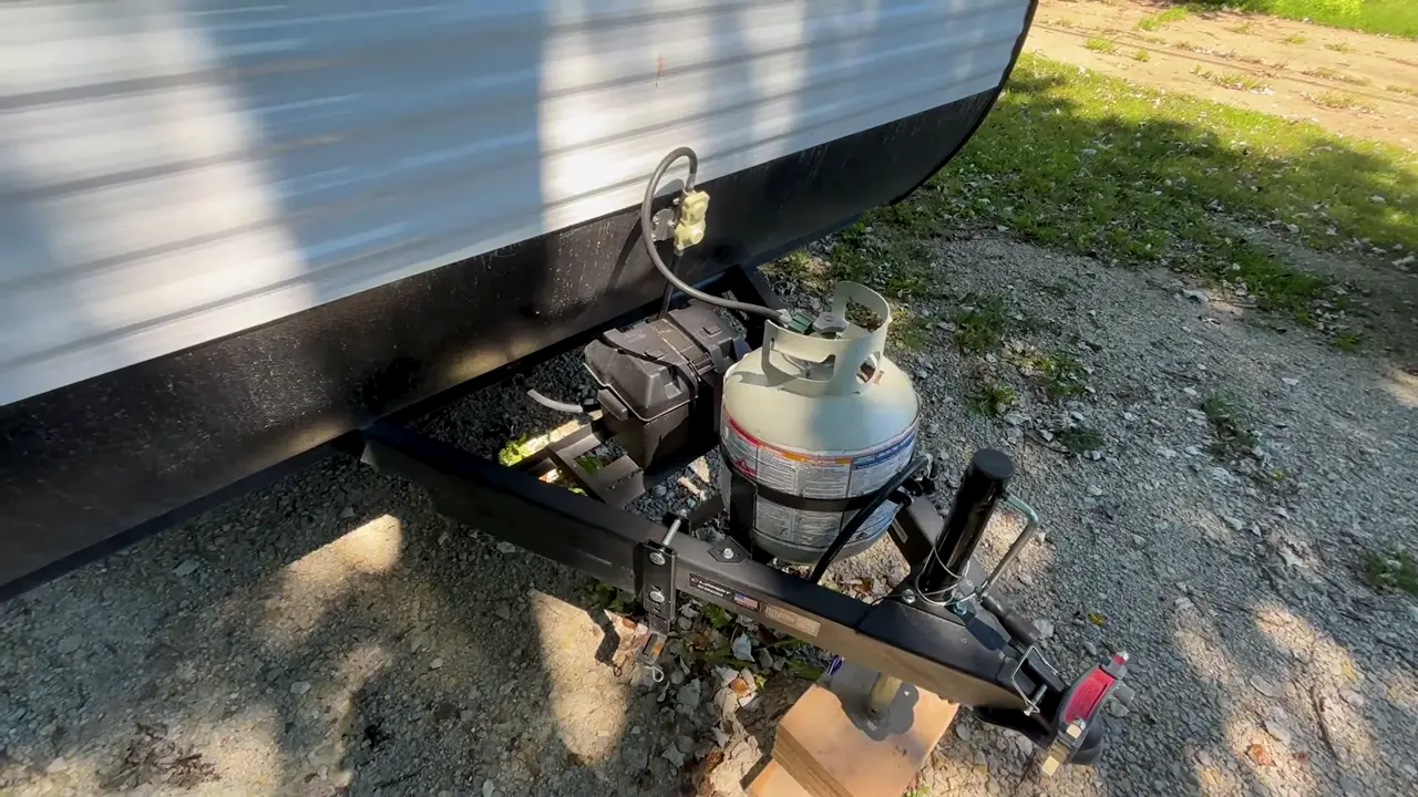 The propane tank and battery box on the tongue of a Coleman travel trailer