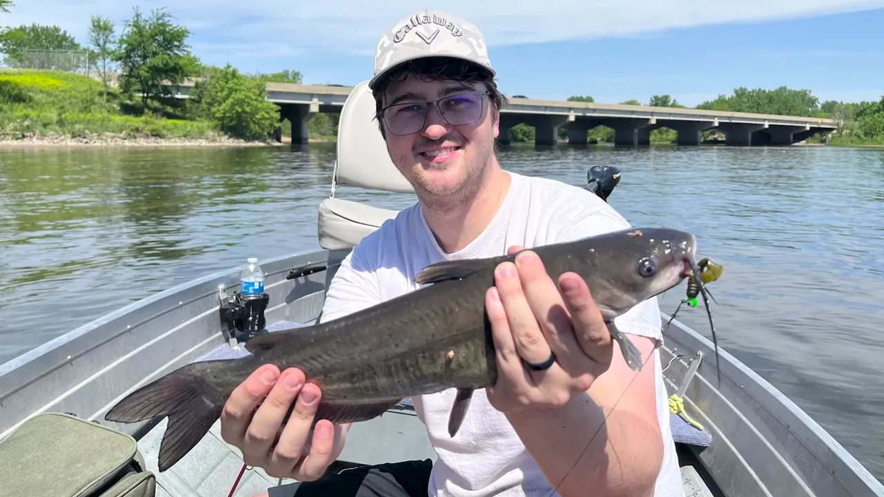 Holding a catfish caught from the 1961 Sea King with the Johnson outboard