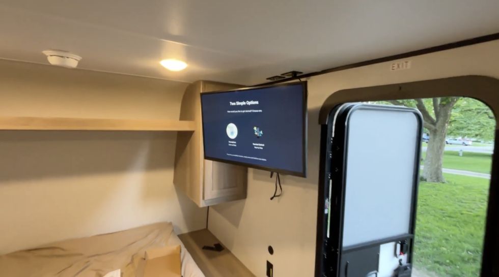 A 32 inch TV mounted on a swivel in a Coleman 17B